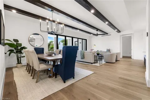 a view of a dining room with furniture and a chandelier
