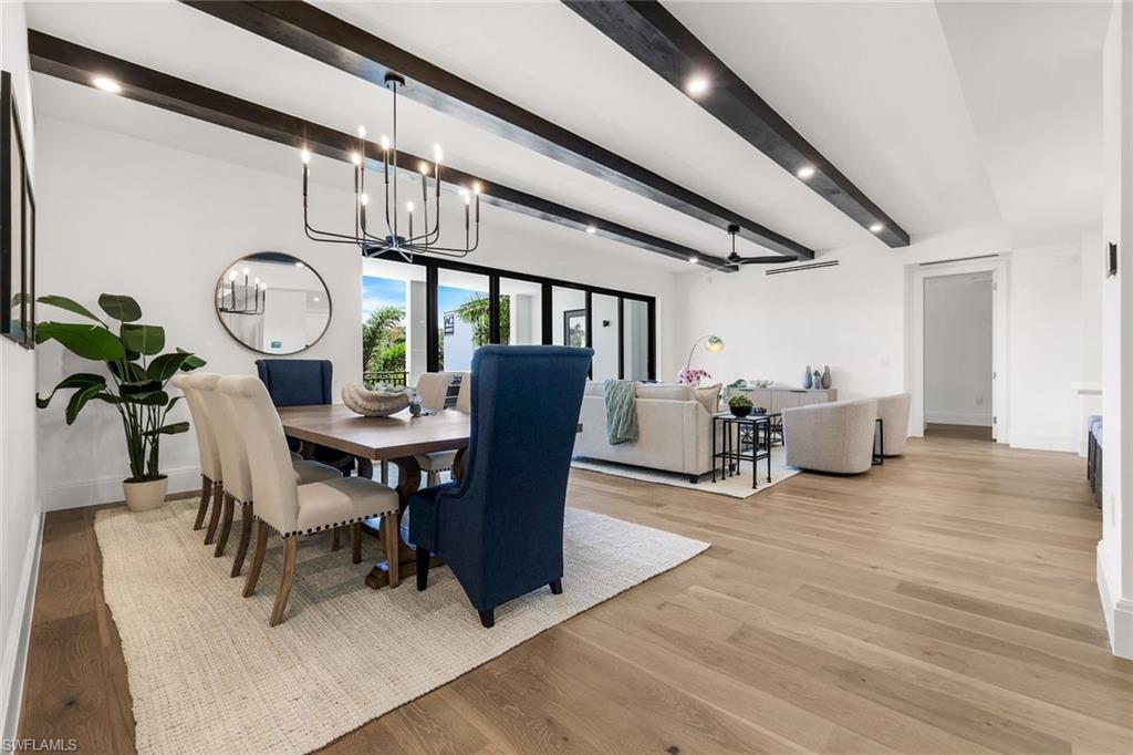 1130 3rd Avenue South, Unit 211 Naples, FL 34102 - Photo 1 of 33 a view of a dining room with furniture and a chandelier