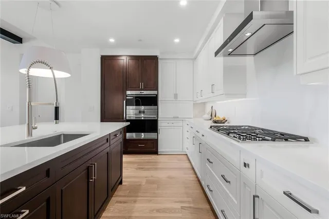a large kitchen with stainless steel appliances granite countertop a stove and a sink