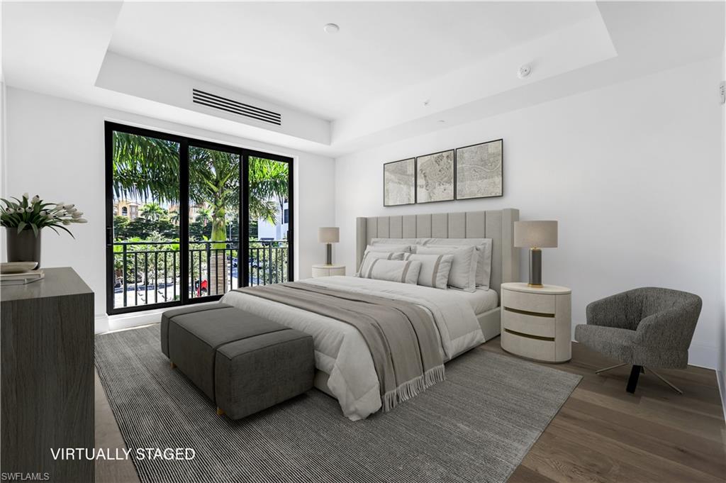 1130 3rd Avenue South, Unit 211 Naples, FL 34102 - Photo 13 of 33 a bedroom with a bed and a large window