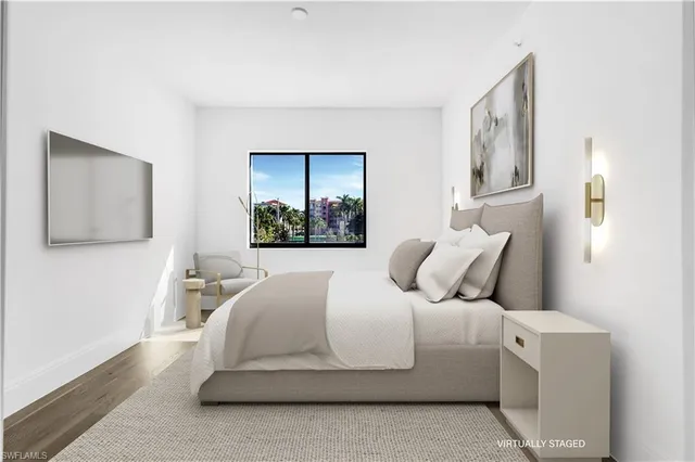 a bedroom with a bed and a painting on the wall