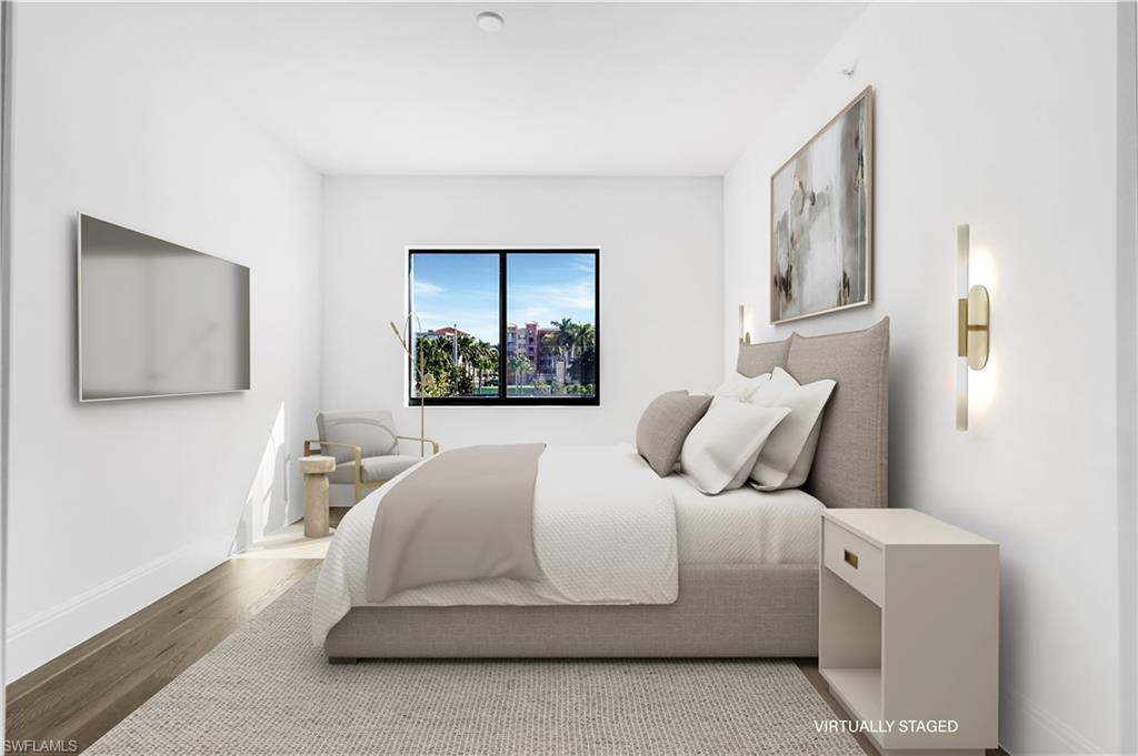 1130 3rd Avenue South, Unit 211 Naples, FL 34102 - Photo 17 of 33 a bedroom with a bed and a painting on the wall