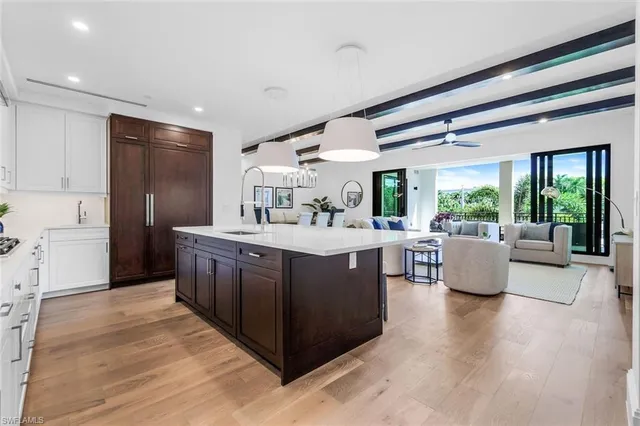 a kitchen with kitchen island wooden cabinets and a wooden floor