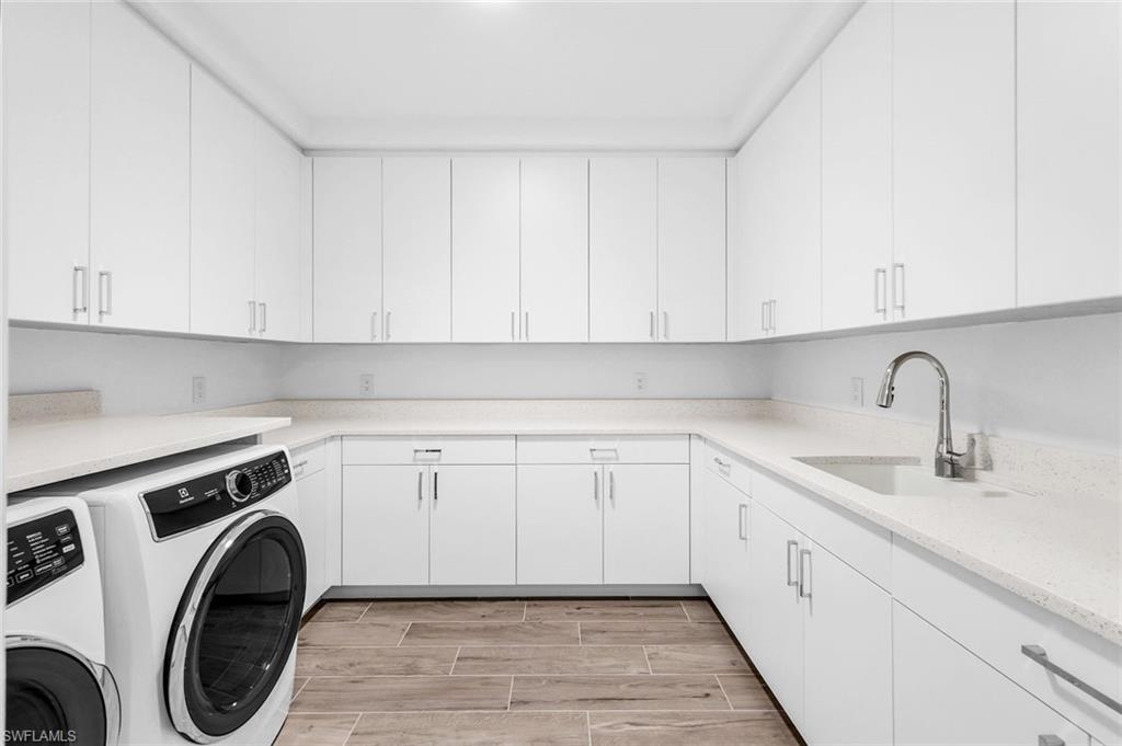 1130 3rd Avenue South, Unit 211 Naples, FL 34102 - Photo 24 of 33 a view of a kitchen with sink washer and dryer