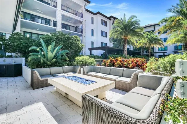a view of a patio with couches and a potted plant on the floor