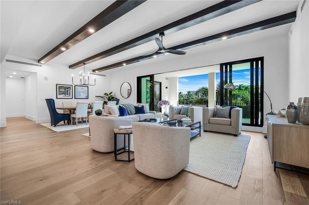 1130 3rd Avenue South, Unit 211 Naples, FL 34102 - Photo 3 of 33 a living room with furniture and a large window