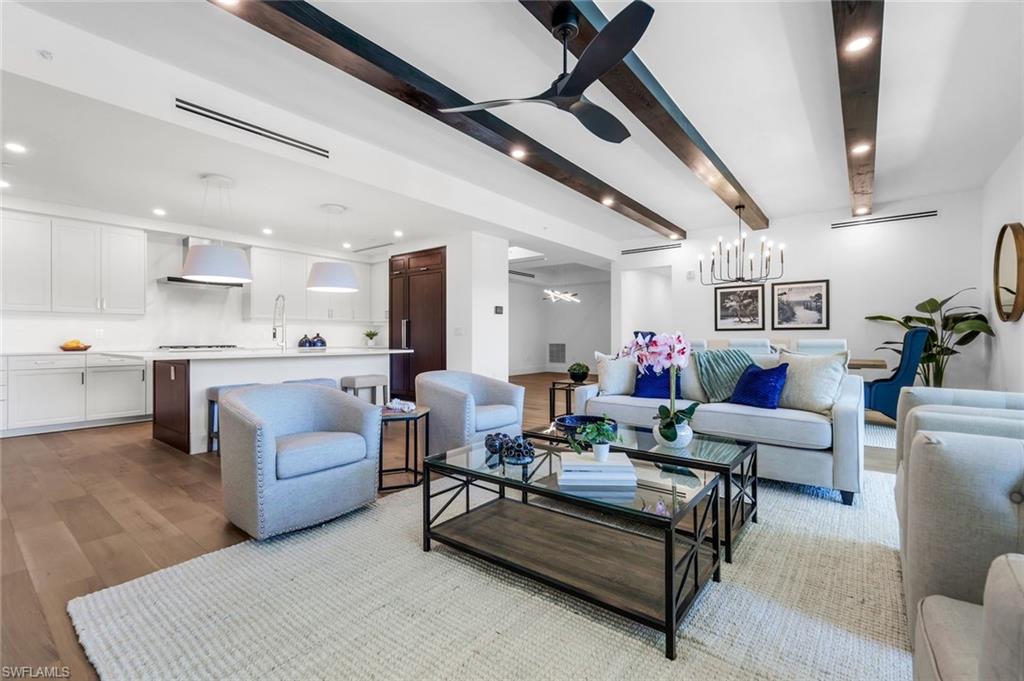 1130 3rd Avenue South, Unit 211 Naples, FL 34102 - Photo 4 of 33 a living room with furniture and a wooden floor