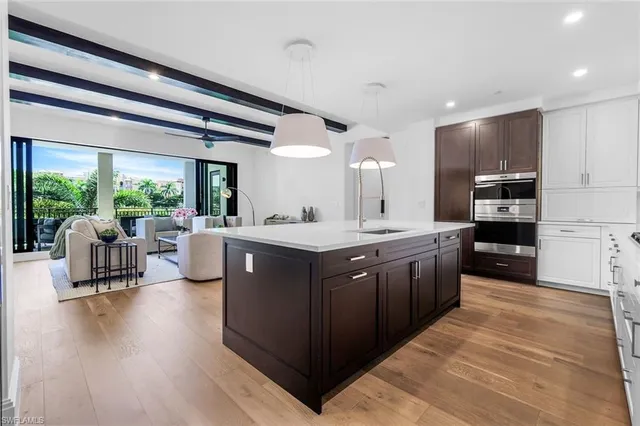 a large kitchen with stainless steel appliances kitchen island granite countertop a large counter top and stainless steel appliances