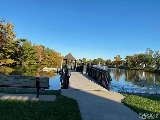 a view of a lake with houses in back