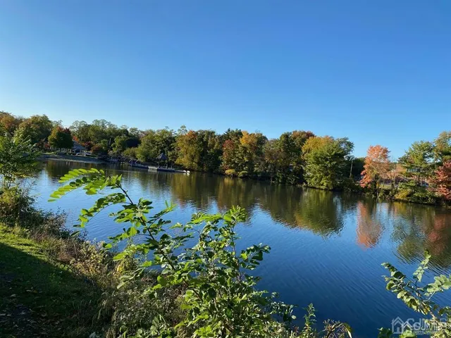 a view of a lake with a house in the background