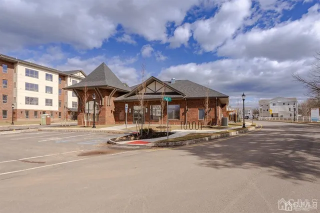 a front view of a house with a garden and street view