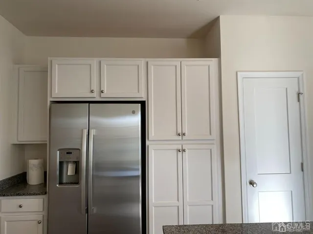 a view of refrigerator in kitchen