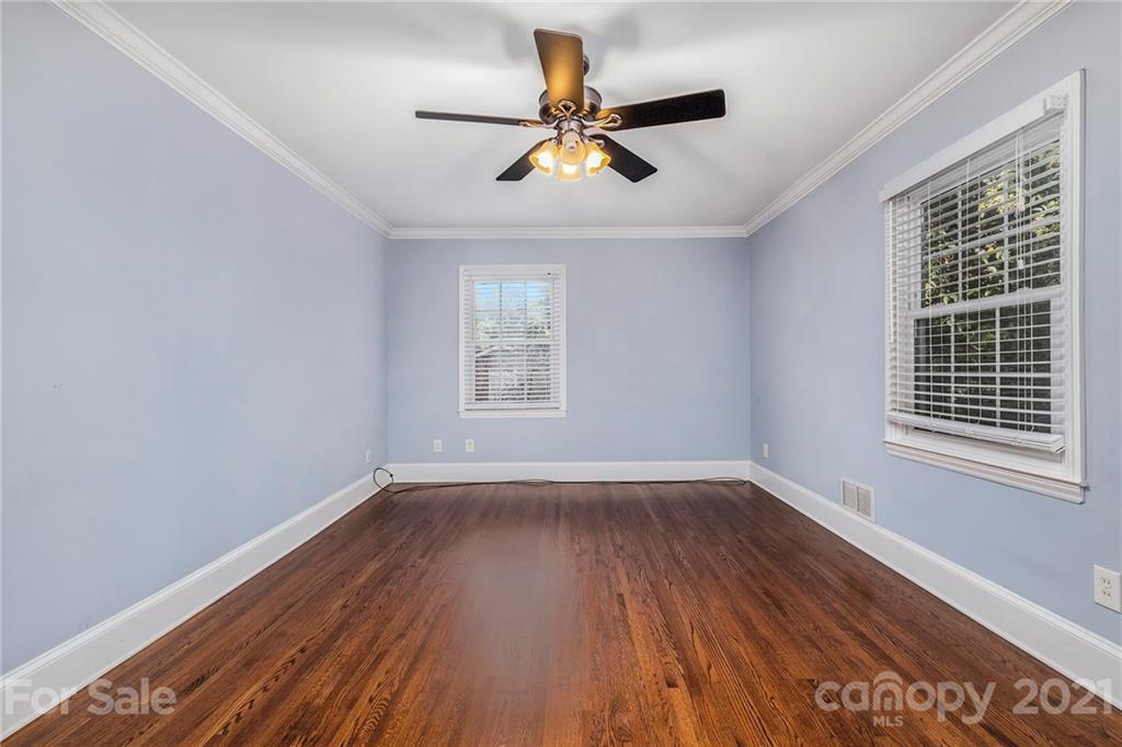 4211 Murrayhill Road Charlotte, NC 28209 - Photo 13 of 18 a view of empty room with wooden floor and fan