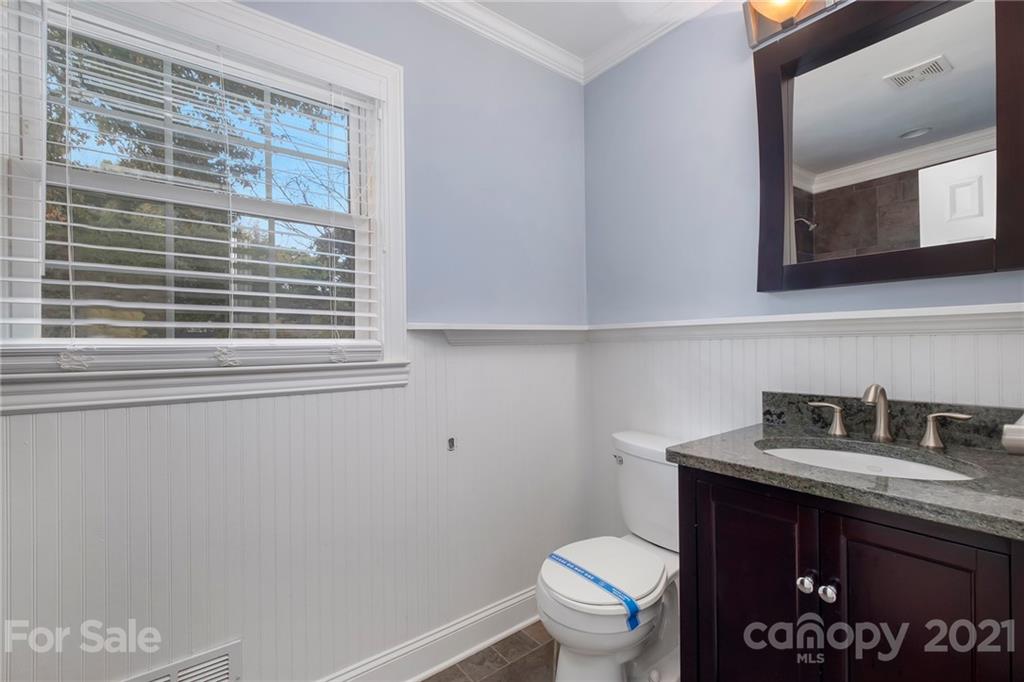 4211 Murrayhill Road Charlotte, NC 28209 - Photo 18 of 18 a bathroom with a sink a toilet and mirror