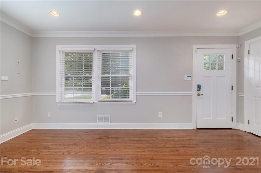 4211 Murrayhill Road Charlotte, NC 28209 - Photo 5 of 18 an empty room with wooden floor and windows
