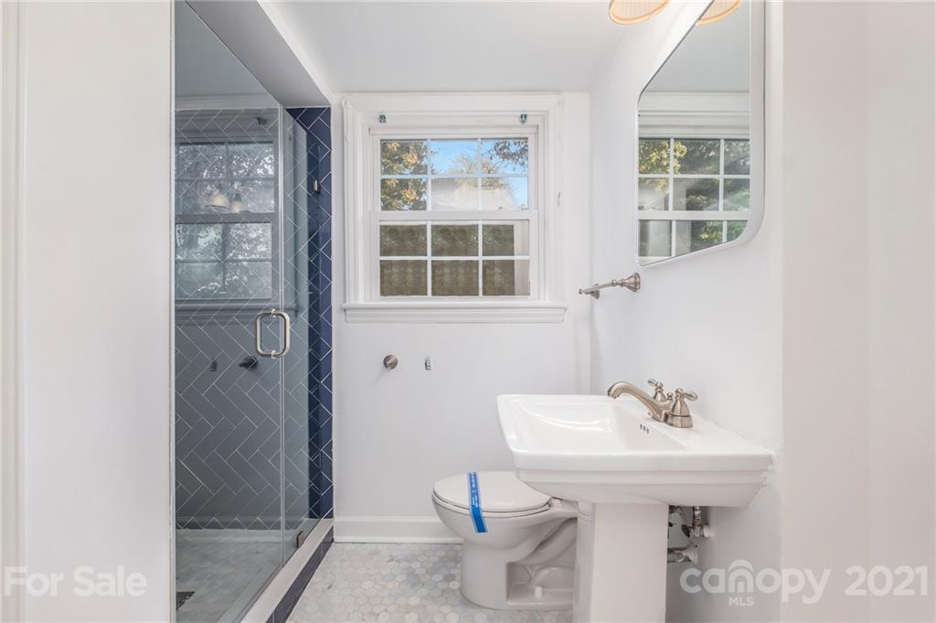 4211 Murrayhill Road Charlotte, NC 28209 - Photo 6 of 18 a bathroom with a sink a toilet and a window