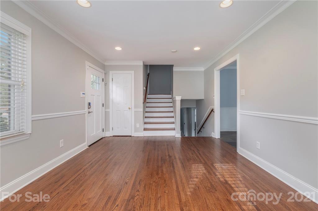 4211 Murrayhill Road Charlotte, NC 28209 - Photo 9 of 18 a view of a hallway with wooden floors and stairs