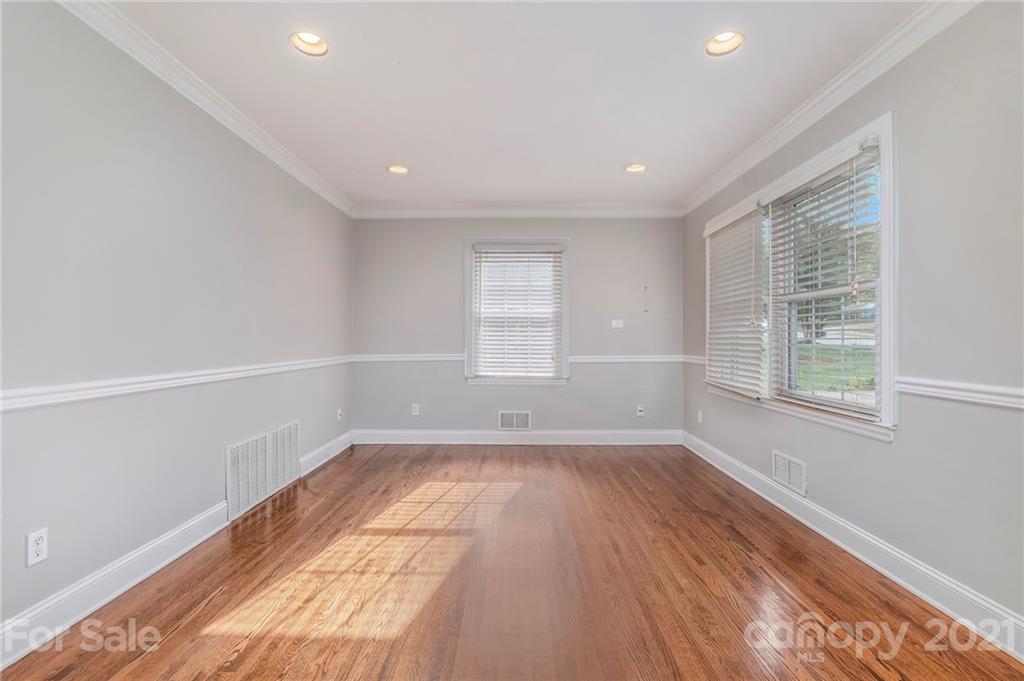 4211 Murrayhill Road Charlotte, NC 28209 - Photo 10 of 18 a view of empty room with wooden floor and fan