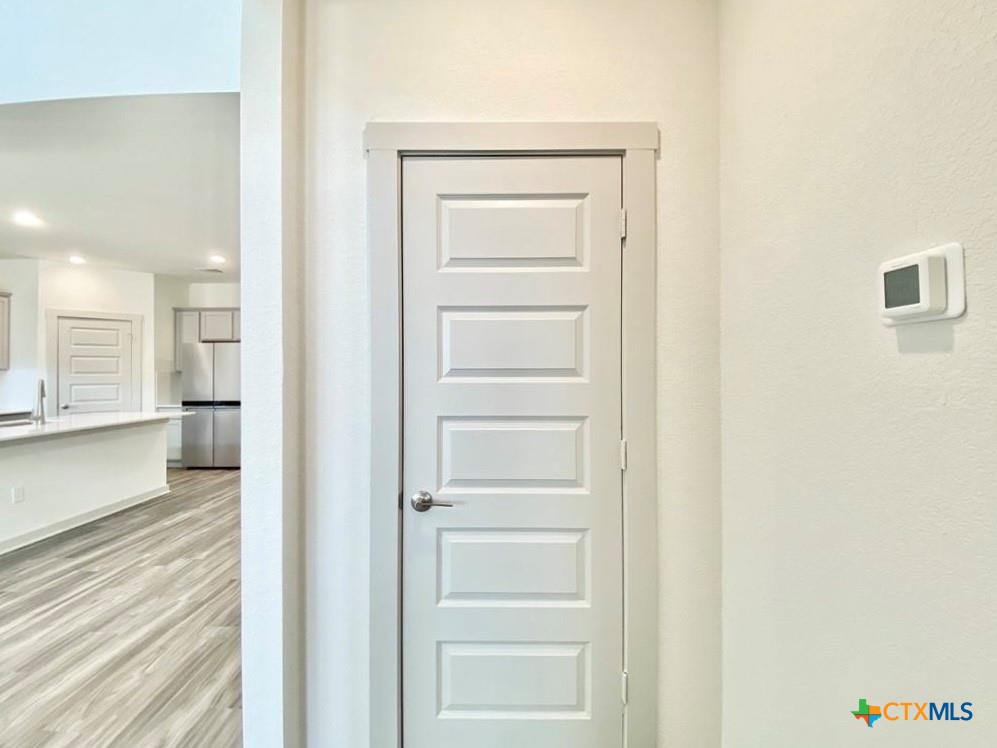100 Geminiflora Bend Leander, TX 78641 - Photo 26 of 38 a view of a hallway with wooden floor