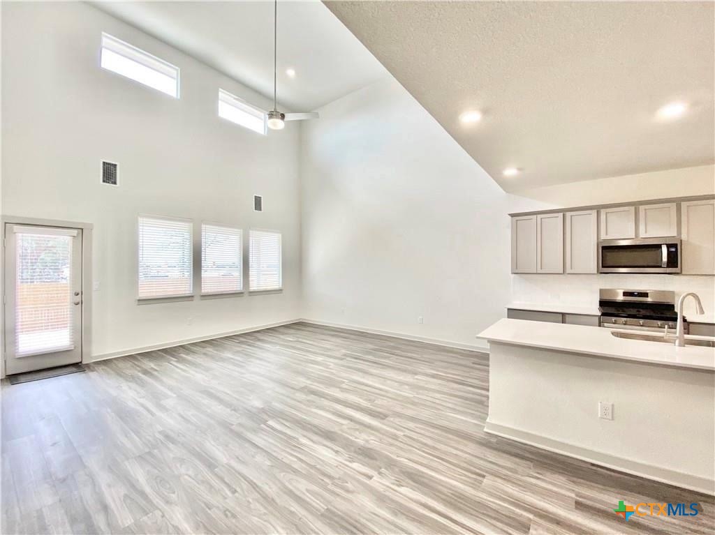 100 Geminiflora Bend Leander, TX 78641 - Photo 4 of 38 a view of a kitchen with microwave and cabinets
