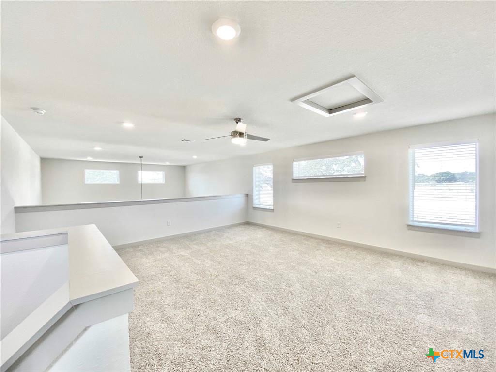 100 Geminiflora Bend Leander, TX 78641 - Photo 5 of 38 wooden floor in an empty room with a window