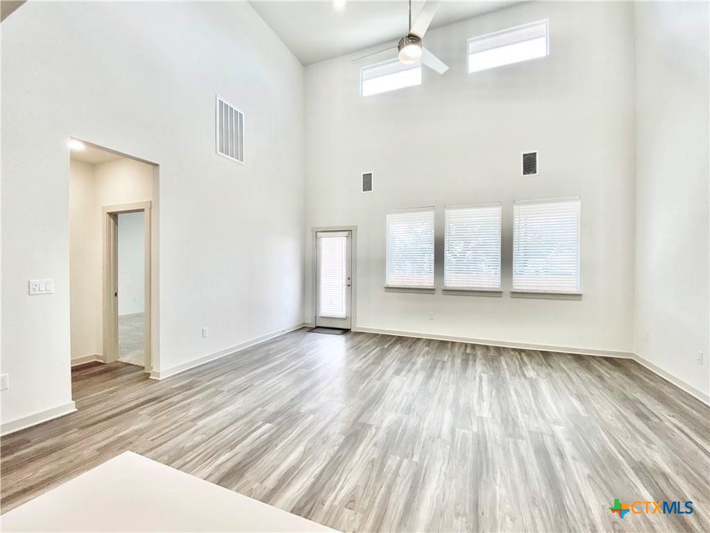 100 Geminiflora Bend Leander, TX 78641 - Photo 6 of 38 wooden floor in an empty room with a window