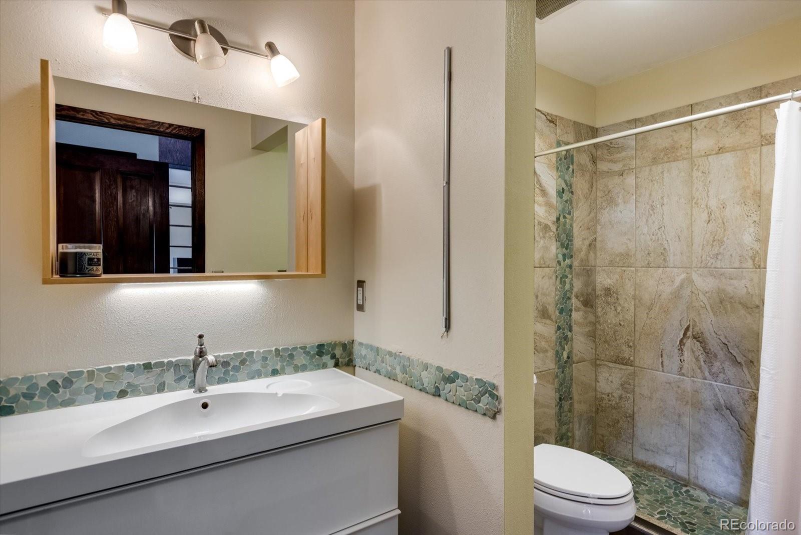 326 Peakview Road Boulder, CO 80302 - Photo 16 of 29 a bathroom with a sink a toilet and shower