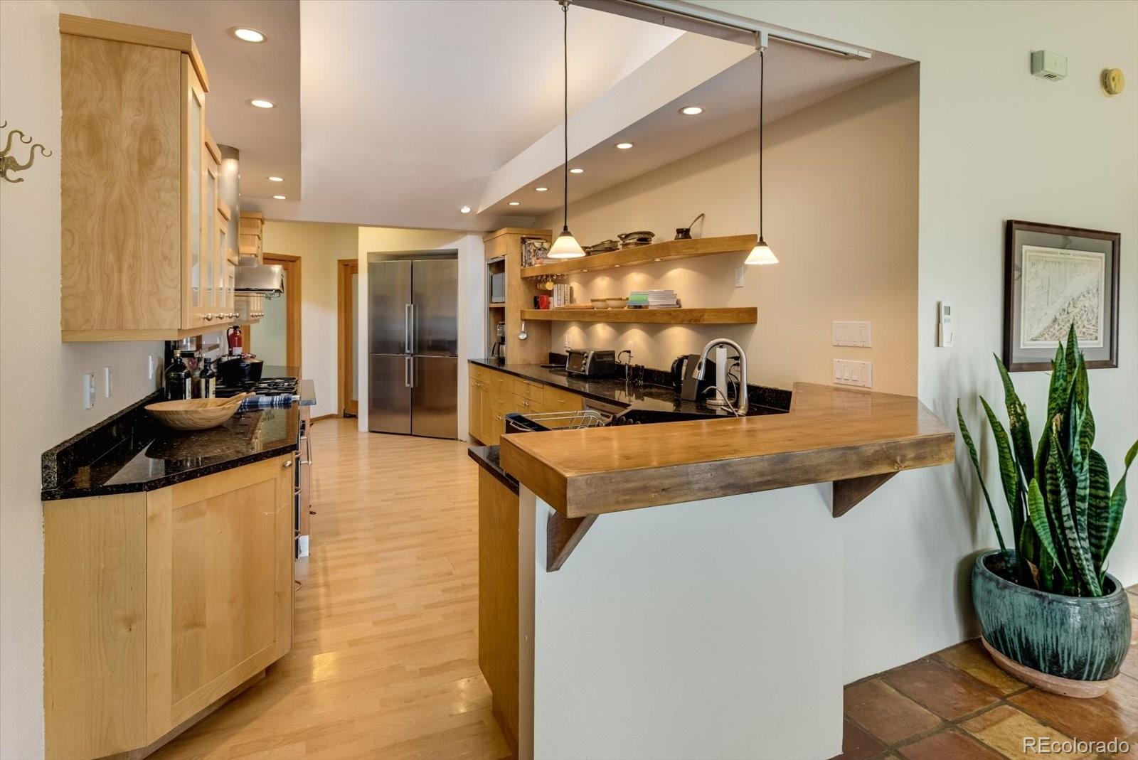 326 Peakview Road Boulder, CO 80302 - Photo 6 of 29 a kitchen with stainless steel appliances granite countertop a stove a sink and a refrigerator