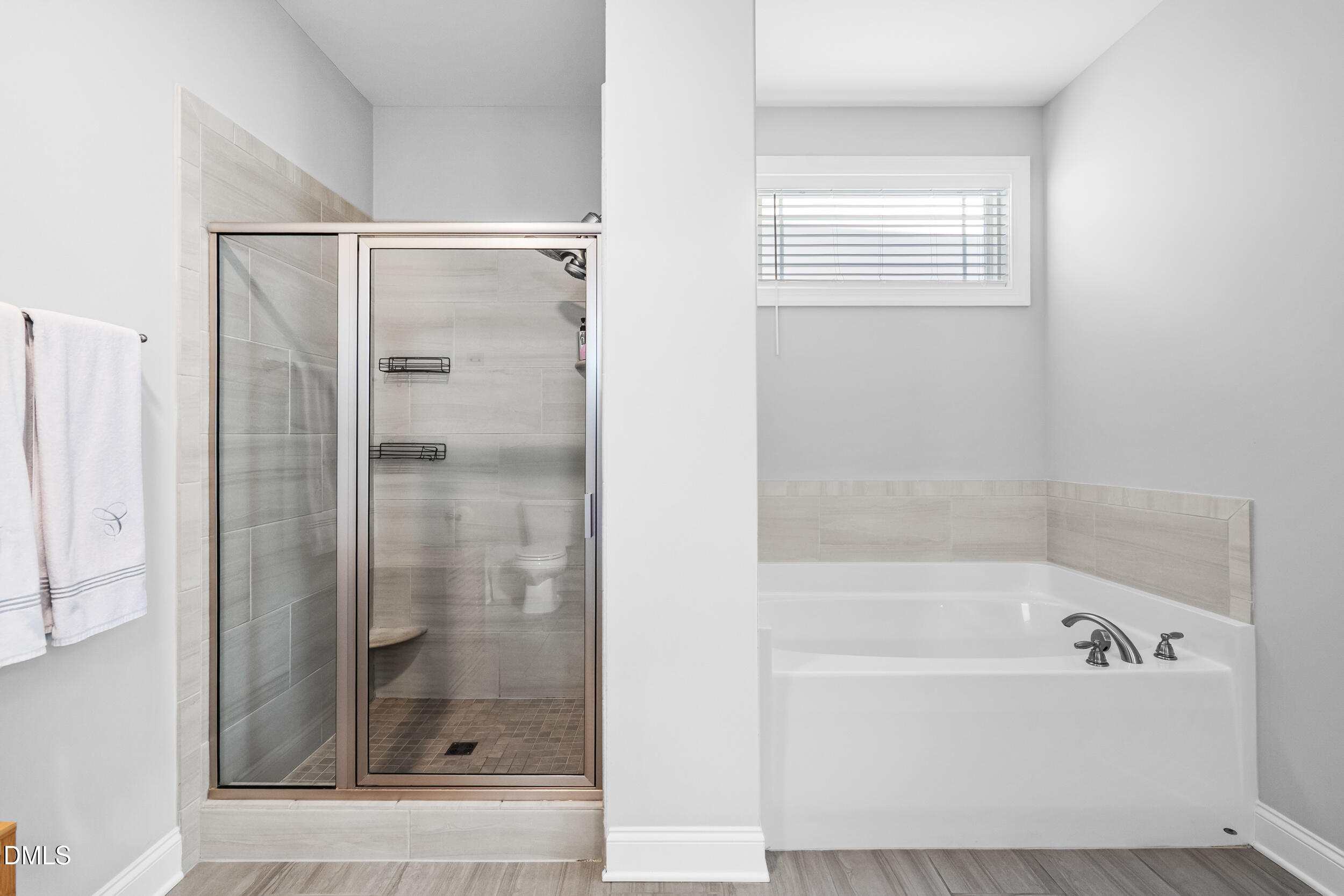 403 Airedale Trail Garner, NC 27529 - Photo 28 of 48 a bathroom with a bathtub and a shower