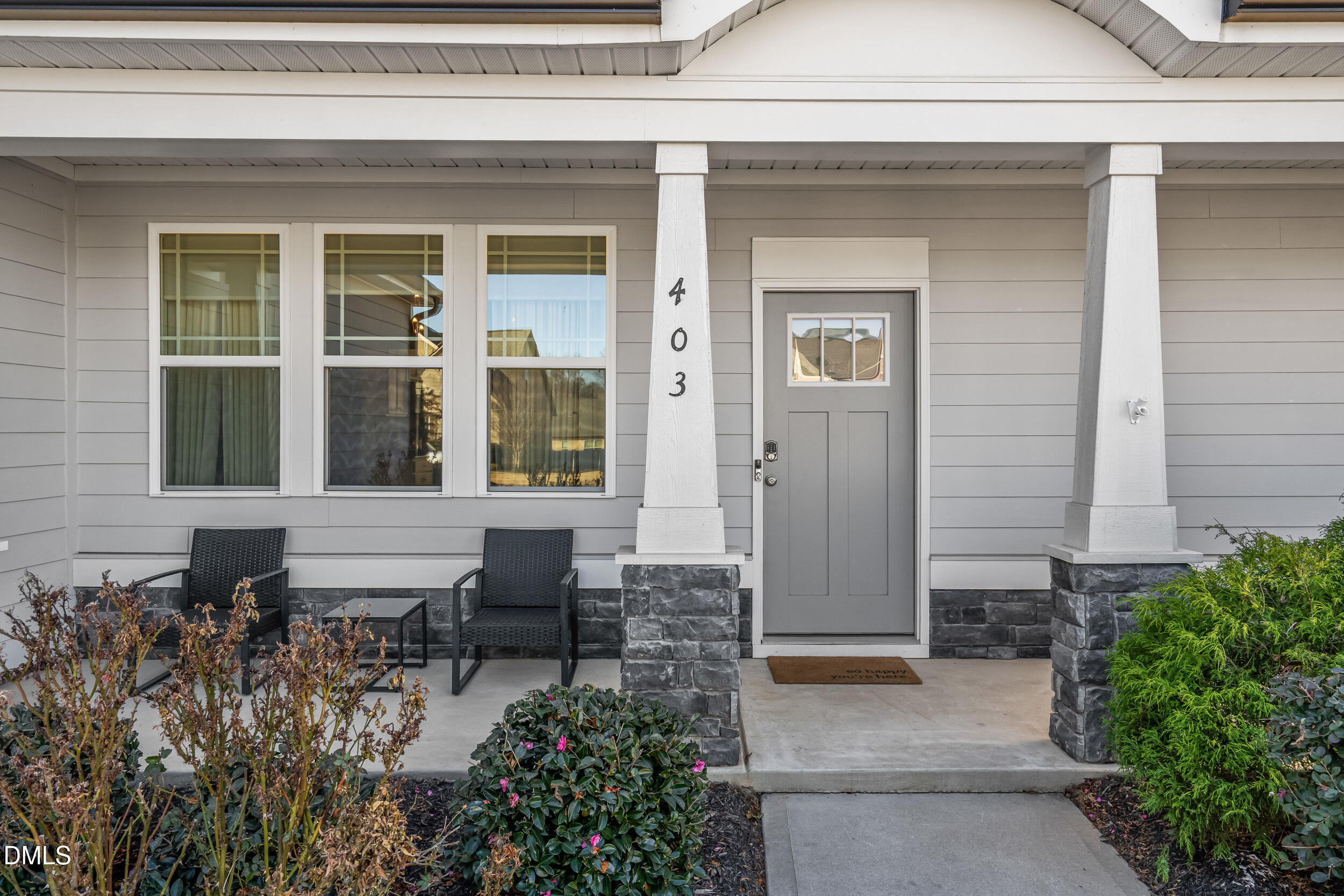 403 Airedale Trail Garner, NC 27529 - Photo 4 of 48 a house with potted plants in front of door