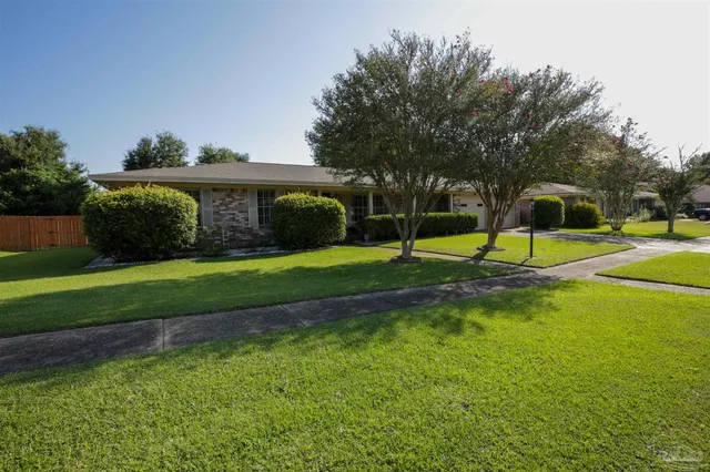 a view of a backyard with swimming pool