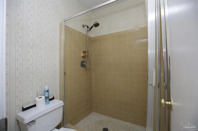 a bathroom with a shower a toilet and sink