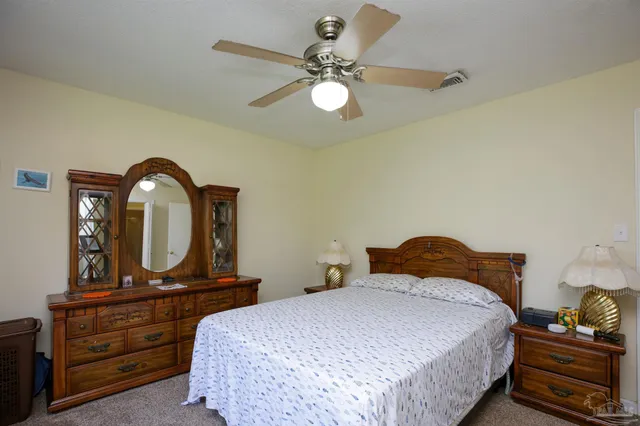 a bedroom with a bed and a dresser