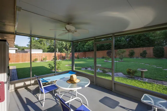 a view of a patio with a table chairs and a backyard