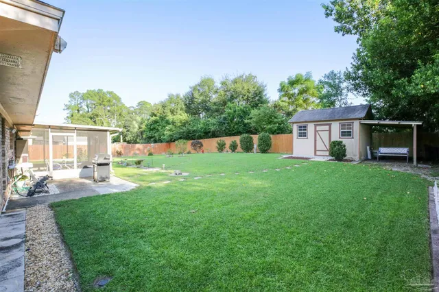 a view of house with backyard
