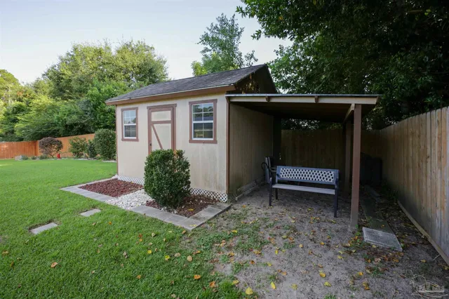 a view of backyard with a barn and a cactus plant