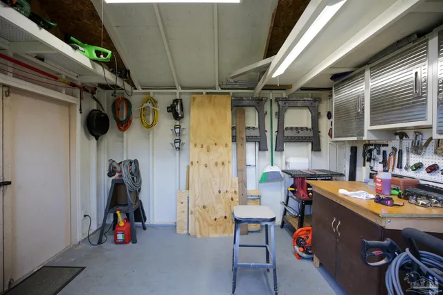a view of a backyard with couches plants and large trees