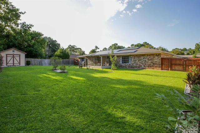 a front view of house with a garden and patio
