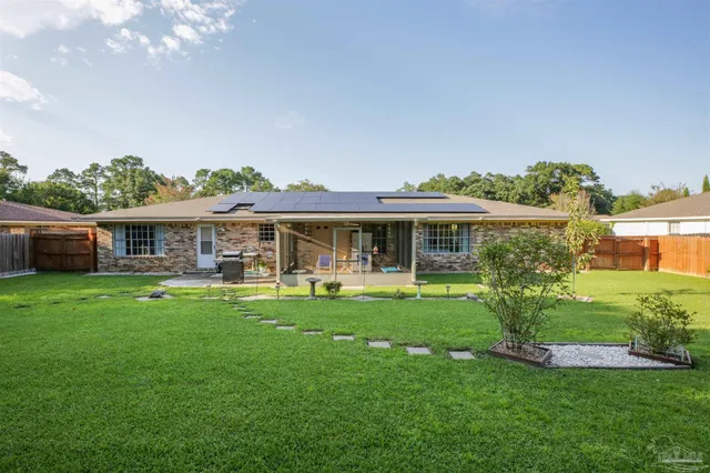 a front view of a house with a yard table and chairs