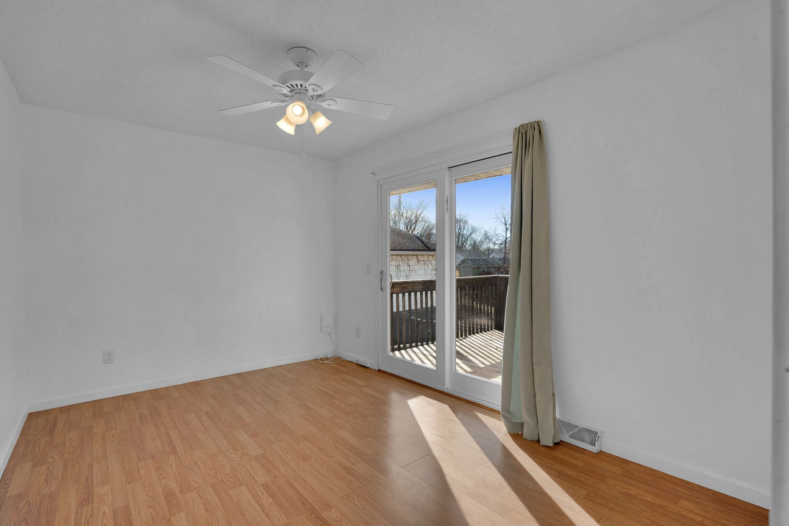 526 29th Avenue West Milan, IL 61264 - Photo 14 of 28 a view of an empty room with wooden floor and a window