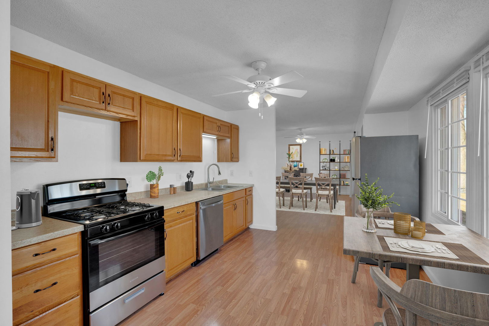 526 29th Avenue West Milan, IL 61264 - Photo 8 of 28 a kitchen with stainless steel appliances kitchen island granite countertop a stove a sink dishwasher a refrigerator a dining table and chairs with wooden floor