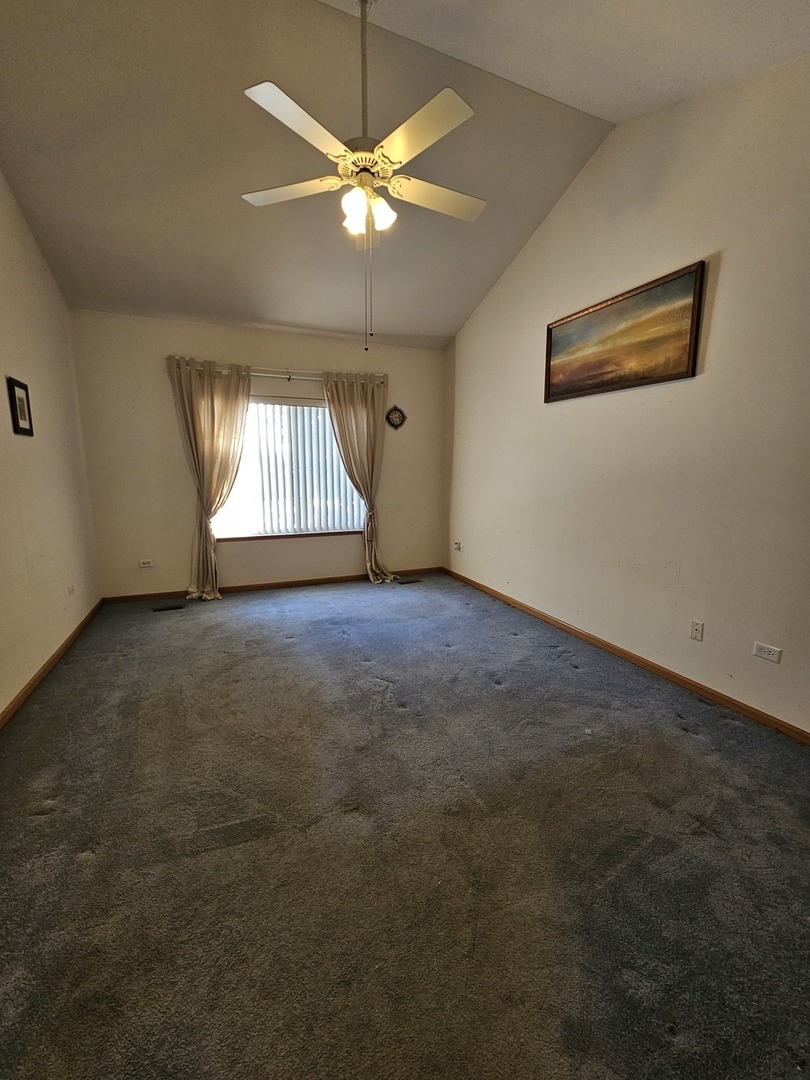 2013 Jeffrey Lane, Unit 2013 Elgin, IL 60123 - Photo 15 of 27 an empty room with a chandelier fan and windows