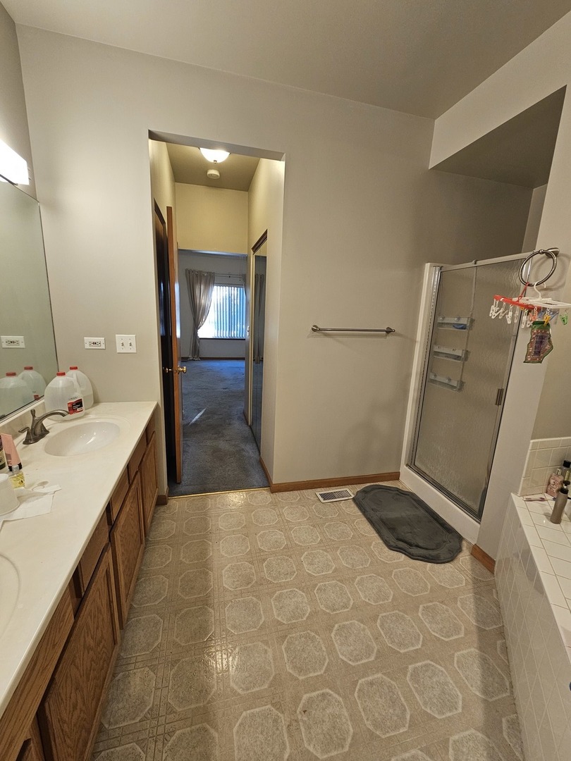 2013 Jeffrey Lane, Unit 2013 Elgin, IL 60123 - Photo 16 of 27 a bathroom with a sink a toilet and mirror