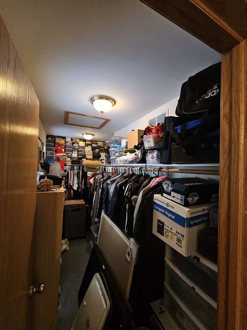 2013 Jeffrey Lane, Unit 2013 Elgin, IL 60123 - Photo 23 of 27 a view of walk in closet with clothes and shoes