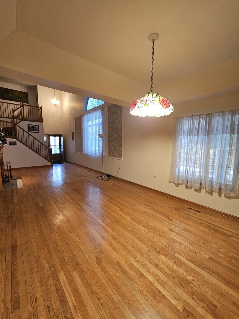 2013 Jeffrey Lane, Unit 2013 Elgin, IL 60123 - Photo 8 of 27 a view of a room with wooden floor gym equipment and windows