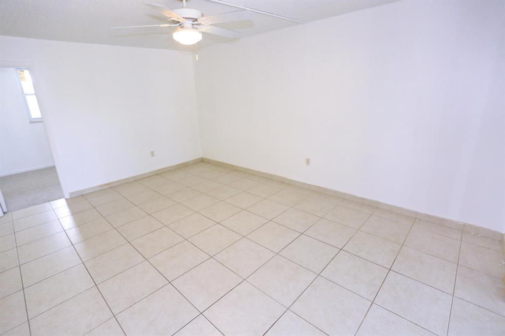 9151 Lime Bay Boulevard, Unit 310 Tamarac, FL 33321 - Photo 11 of 30 a view of a room with a chandelier fan and fire place