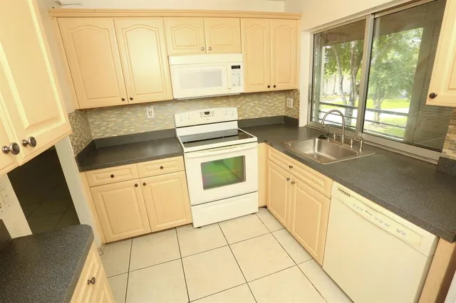 a kitchen with a sink and a refrigerator