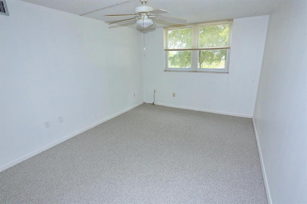 9151 Lime Bay Boulevard, Unit 310 Tamarac, FL 33321 - Photo 19 of 30 an empty room with a window