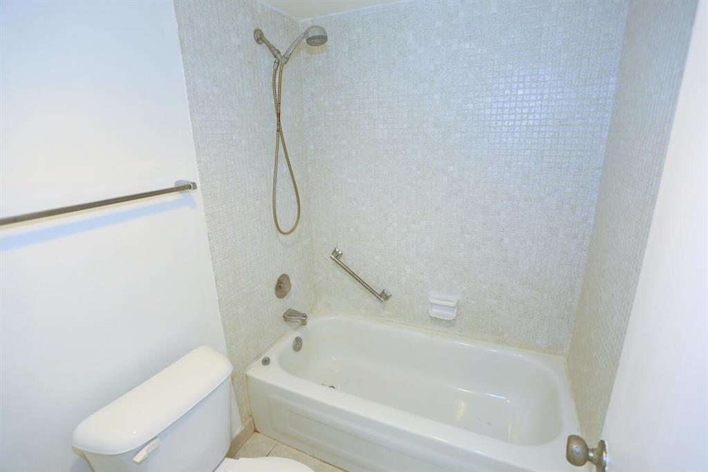 9151 Lime Bay Boulevard, Unit 310 Tamarac, FL 33321 - Photo 21 of 30 a bathroom with a toilet and a bath tub