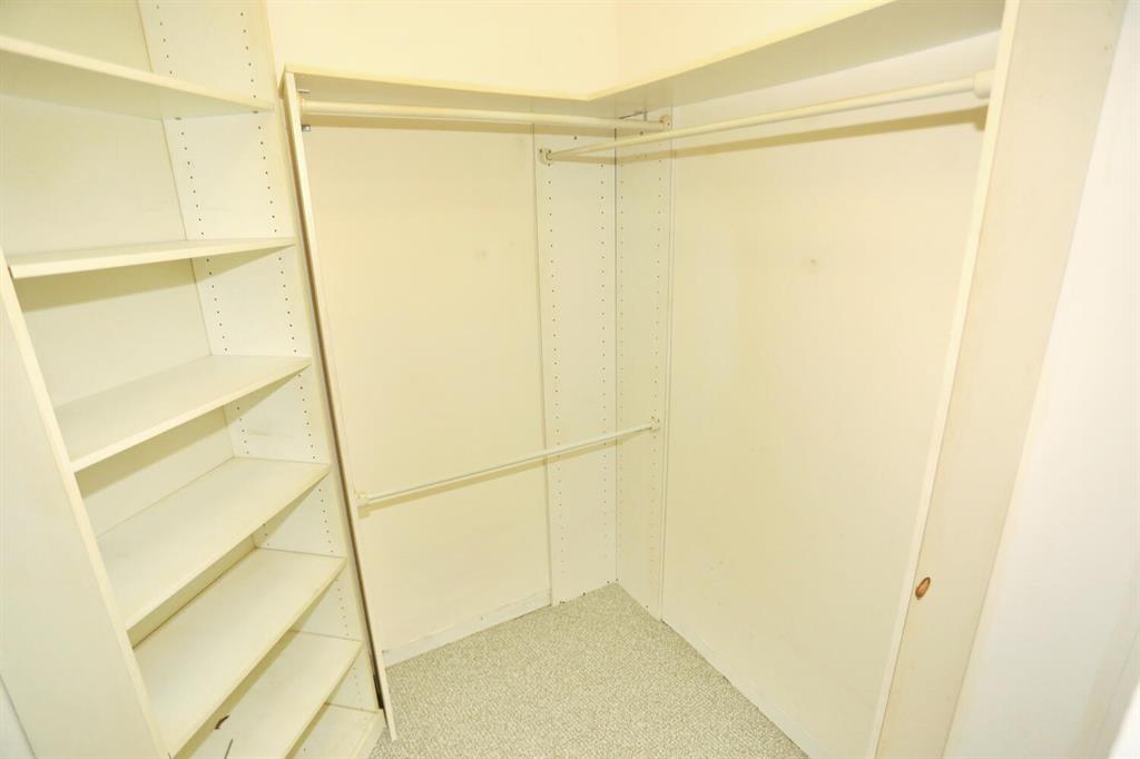 9151 Lime Bay Boulevard, Unit 310 Tamarac, FL 33321 - Photo 22 of 30 a bathroom with a glass shower door